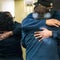 People embrace after learning their loved one was safe after a mass shooting at the FedEx facility in Indianapolis, Indiana, April 16, 2021. 