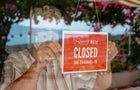 Business Owner With Face Mask Putting Closed Sign 