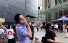 People gather outside the 73-storey SEG skyscraper in Shenzhen 