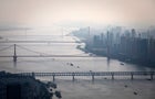 Bridges over the Yangtze River are seen from the Wuhan Greenland center during its construction August 11, 2020, in Wuhan, China. 