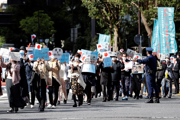 Protesters hold banners during a march against the marriage between Japan's Princess Mako and her fiance Kei Komuro in Tokyo 