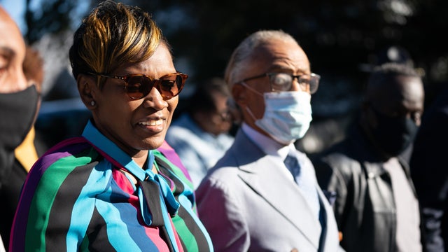 Wanda Cooper-Jones, mother of Ahmaud Arbery, arrives at the Glynn County Courthouse with the Rev. Al Sharpton as the jury deliberates in the trial of the killers of Ahmaud Arbery on November 24, 2021, in Brunswick, Georgia. 
