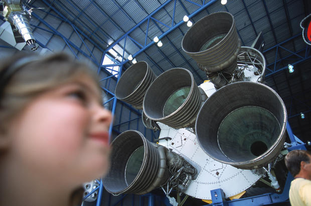 Girl next to Rocket Engines, Cape Canaveral, Kennedy Space Center, Florida, USA. 