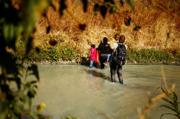 Asylum-seeking migrants cross the Rio Bravo river to turn themselves in to U.S. Border Patrol agents to request asylum in El Paso, Texas, U.S., as seen from Ciudad Juarez 