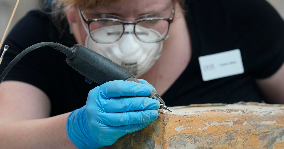 Books, envelope and silver coin found in time capsule beneath former Robert E. Lee statue