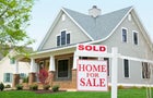 House with ""sold"" sign in front yard 