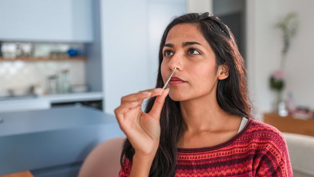 Close Up Of An Indian Young Woman Getting Taking A Covid Self Test In The Kitchen 