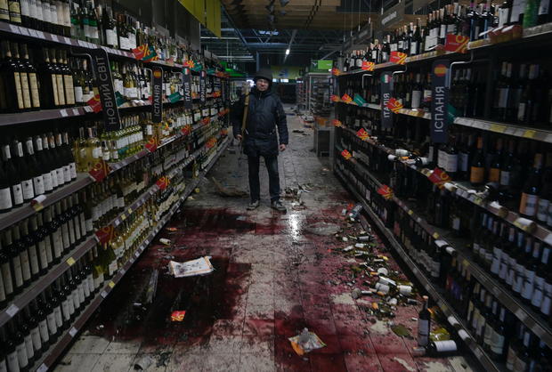 A member of the Ukrainian Territorial Defence Forces stands inside a supermarket in Bucha 