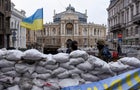 Soldiers stand guard behind a barricade, with the Odessa National Academic Opera and Ballet Theatre seen in the background, amid Russia's invasion of Ukraine, in Odessa 
