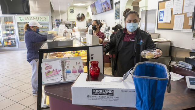 People shop with face coverings in Newhall, CA.  LA County may issue a public health order on Friday to end the requirement to wear masks indoors. 