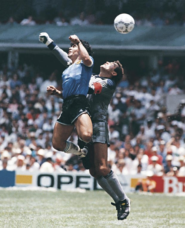 Diego Maradona of Argentina uses his hand to score the first goal of his team during a 1986 FIFA World Cup quarter-final match between Argentina and England at Azteca Stadium on June 22, 1986, in Mexico City, Mexico. Maradona later claimed that the goal was scored by 