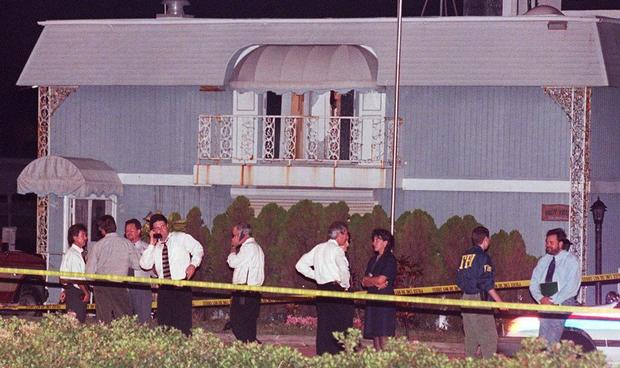 Miami Beach police and FBI agents surround a house 