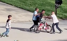 Neighborhood kids teach boy to ride a bike 