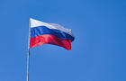 Low Angle View Of Flag Against Blue Sky 