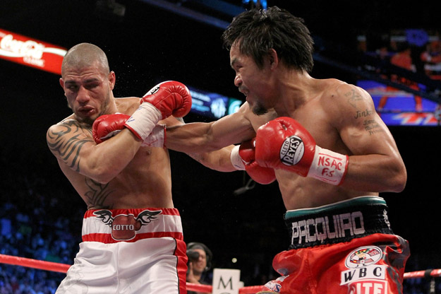 Manny Pacquiao throws a right to the head of Miguel Cotto.
